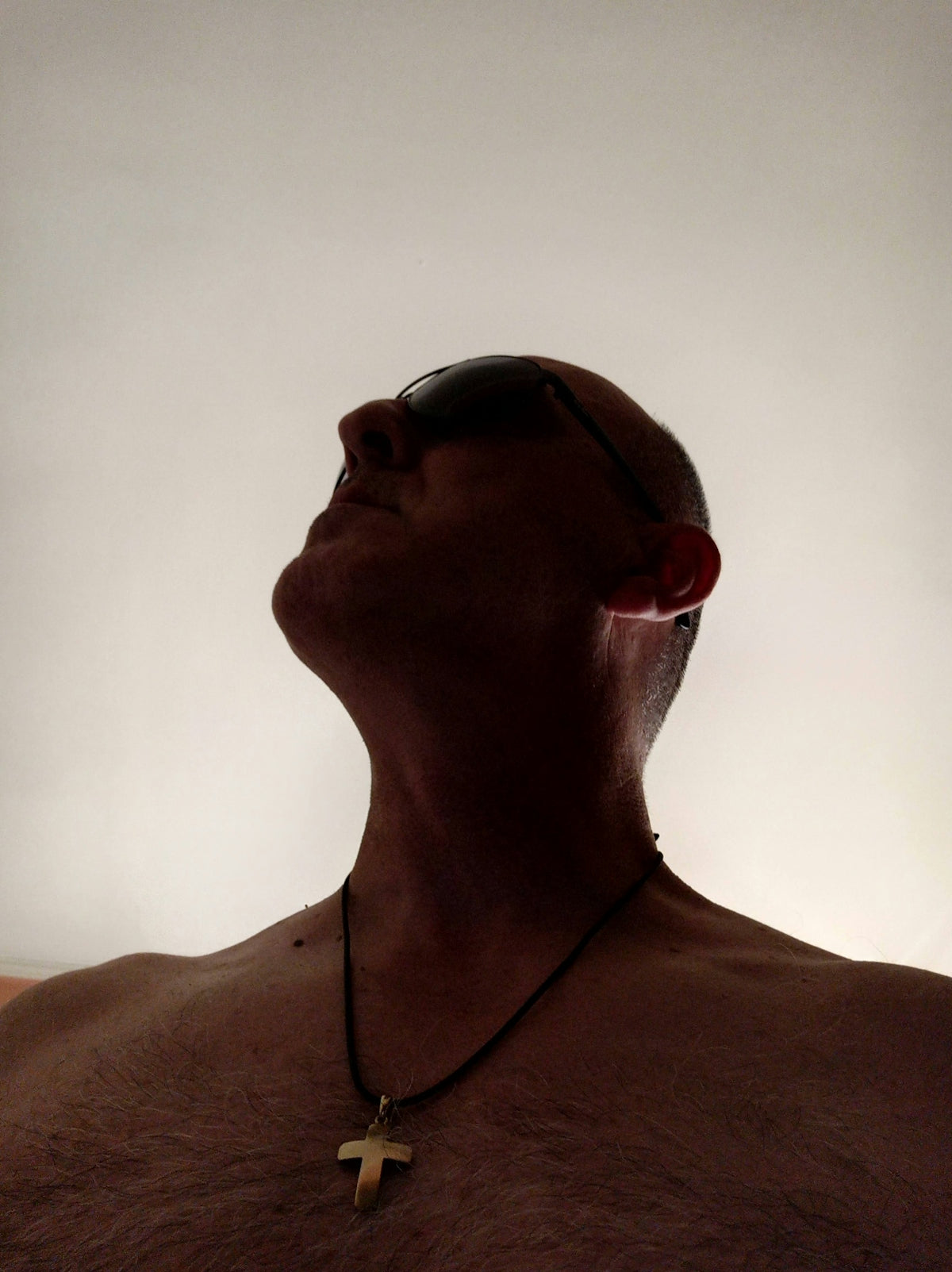 a man with a cross necklace on his neck